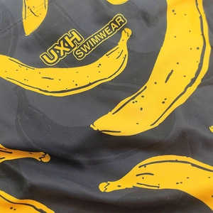 Gros plan détaillé sur le tissu de bain noir avec motif imprimé de bananes jaunes vives