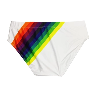 Close-up of men's white bikini swimwear featuring vibrant rainbow striped print detail