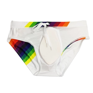 Detailed view of men's white swim briefs featuring rainbow stripes and removable padding
