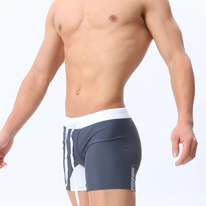 Close-up of men's quick-dry swim trunks with white drawstring and side stripes