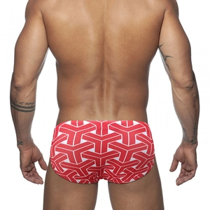 Macro view of men's swim briefs featuring red and white geometric Y-pattern textures
