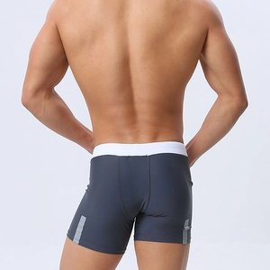 Detail view of men's dark gray swim shorts featuring a white waistband and reflective side stripes