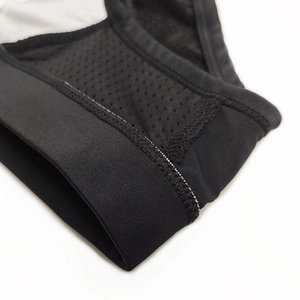 Macro shot of breathable black mesh fabric and elastic seams on men's swim briefs