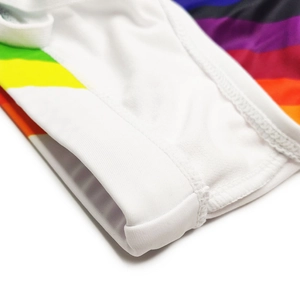 Close-up of white swimwear fabric featuring colorful rainbow side stripes and flatlock stitching