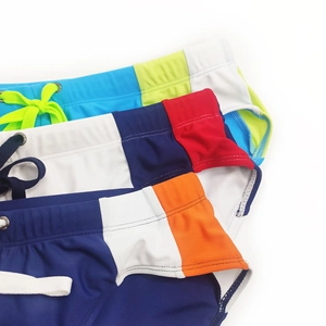 Detailed view of men's quick-dry swimwear featuring contrast drawstrings and color-blocking