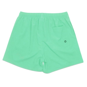 Detail of mint green quick-dry beach shorts featuring elastic waist and back pocket with vent