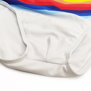 Close-up of vibrant rainbow stripes and durable stitching on white men's swim briefs