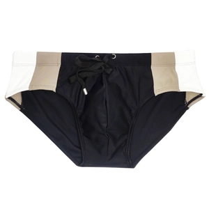 Detail of men's color-block swim briefs featuring drawstring waist and elastic fabric
