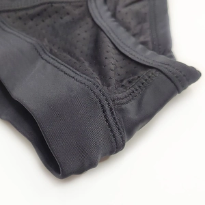 Detail of black breathable mesh fabric and reinforced stitching on men's swim briefs