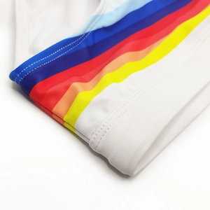 Detailed close-up of colorful striped elastic fabric with professional double stitching