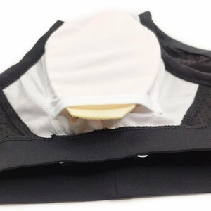Detail of breathable white mesh lining and removable cup pads inside black swim briefs