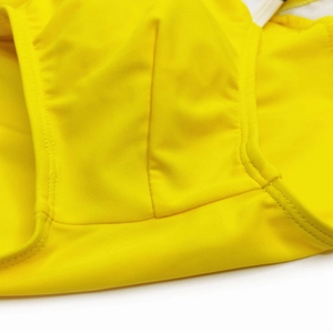 Detailed close-up showing reinforced stitching on yellow high-elastic men's swim briefs
