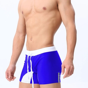 Detail of blue and white men's swim trunks featuring drawstring waist and reflective strips