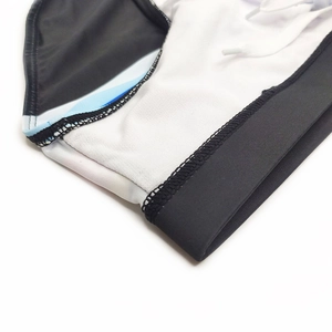 Detailed macro view of the elastic waistband and stitching on striped men's swim briefs