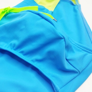 Detailed view of blue men's swim briefs with neon yellow drawstring and neat stitching