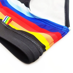Macro detail of rainbow striped swimwear fabric with white contrast stitching and trim