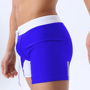 Detail of men's blue swimming trunks featuring adjustable drawstring and reflective stripes