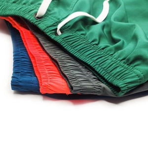 Detail view of colorful quick-dry running shorts with elastic waist and drawstrings