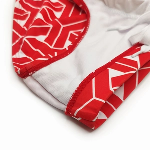 Close-up of red and white geometric print swim briefs with adjustable white drawstring
