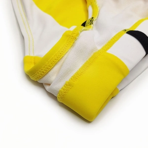 Macro detail of high-density flatlock stitching on tricolor men's swim trunks fabric
