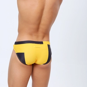Rear view detail of men's yellow and black geometric print triangle swim briefs