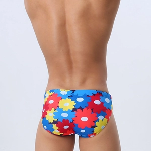 Rear view of men's swim briefs featuring vibrant colorful floral patterns on white background