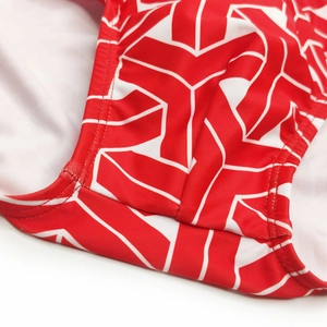 Detailed macro view of professional double-needle stitching on patterned swim briefs