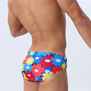 Men's sexy swimming briefs featuring vibrant multicolor floral print and snug fit