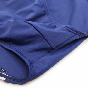 Detail of dark blue swim briefs showing elastic fabric, double stitching and white lining