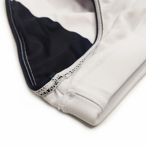 Detail view of contrast stitch seam and high-elastic fabric on men's swim briefs