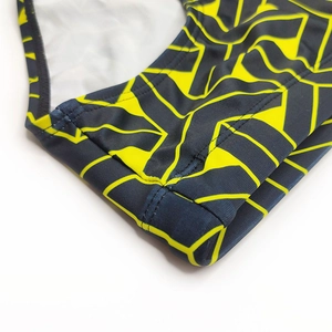 Macro shot of men's swimming briefs with yellow geometric print and durable flatlock seams