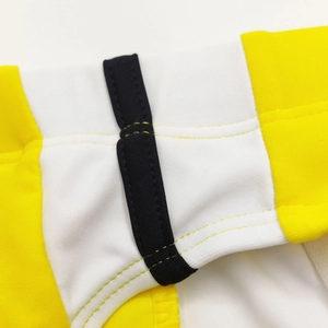Detail view of the stitching and elastic band on yellow and white contrast swim briefs