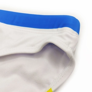 Detail of white swimwear with blue elastic waistband and yellow side accents for men