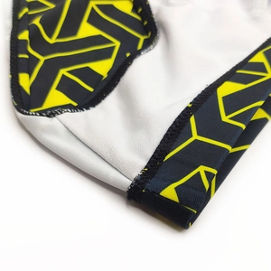 Detail of men's swimming briefs showing black and yellow geometric print and reinforced seams