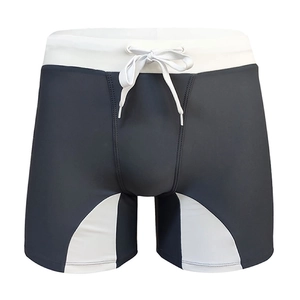Close-up of men's athletic swimming trunks featuring reflective trim and drawcord waist