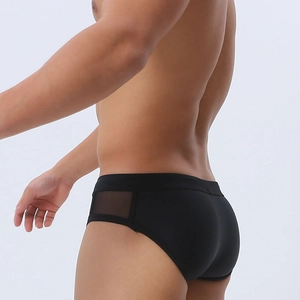 Detail of men's black swim briefs featuring side mesh panels and premium athletic fabric