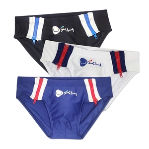 Detail of men's swimming briefs with side metal zippers and UXH logo on quick-dry fabric