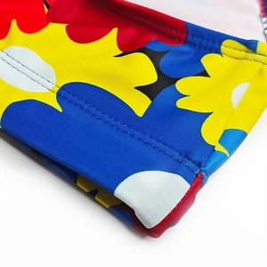 Macro shot of colorful floral pattern and durable double-stitch seams on men's swimwear