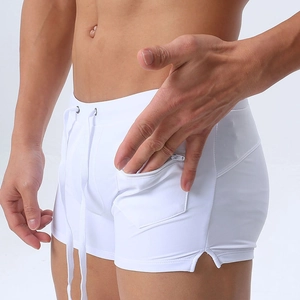 Detail of white men's swim trunks featuring an adjustable drawstring and side zipper pocket