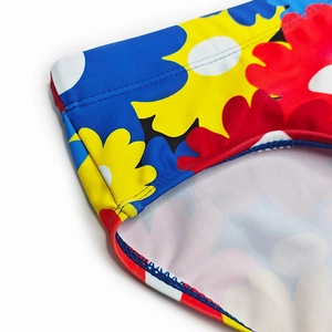 Macro view of colorful floral print and double-stitched seam on men swimwear fabric