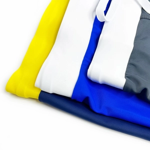 Detail of multi-colored athletic swim trunks with adjustable waist drawstrings and elastic fabric