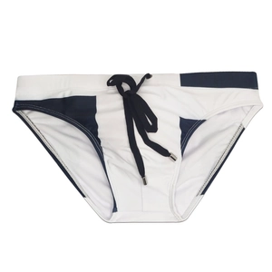 Detail of men's swim briefs showing geometric拼接 design and drawstring with metal tips