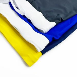 Close-up of colorful men's swim trunks in yellow, blue, white, and grey with waist drawstring