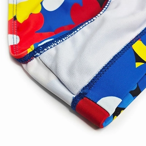Close-up of flatlock stitching and vibrant abstract floral print on men's swim briefs