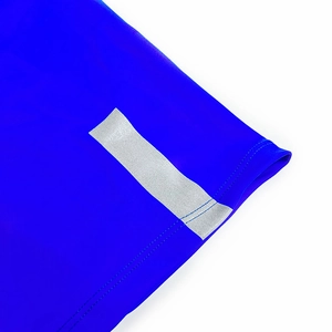 Detail of reflective safety stripe on bright blue quick-dry athletic swimming shorts