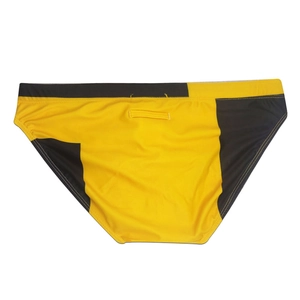 Detail of men's low-rise swim briefs with yellow and black contrast stitching