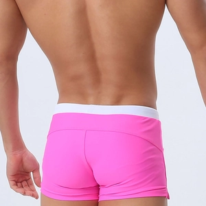 Rear view of tight-fitting pink men's swim trunks with white elastic waistband contrast