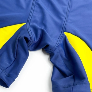 Detail shot of blue and yellow men swim shorts showing reinforced stitching seams