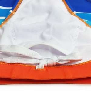 Detail of men's swim briefs showing orange elastic waistband with white drawstring and lining