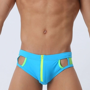 Detail of blue men's swim briefs featuring front zipper and green hollow-out sides